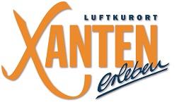 Logo der Stadt Xanten. Es ist in dunkelblau zu lesen "Luftkurort". Darunter in orange "Xanten". Darunter in dunkelblau 2erleben".